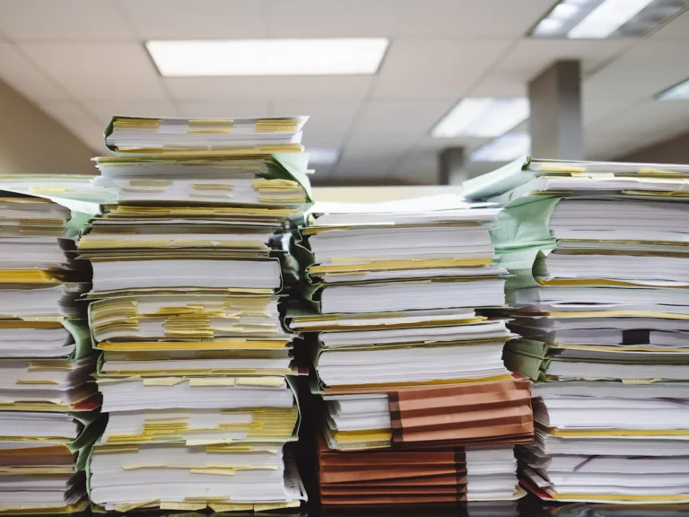 Stacks of paper documents and file folders