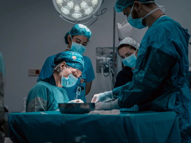 A group of doctors performing surgery on a patient