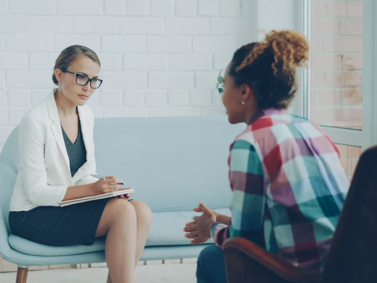 Two women talking in a therapy session