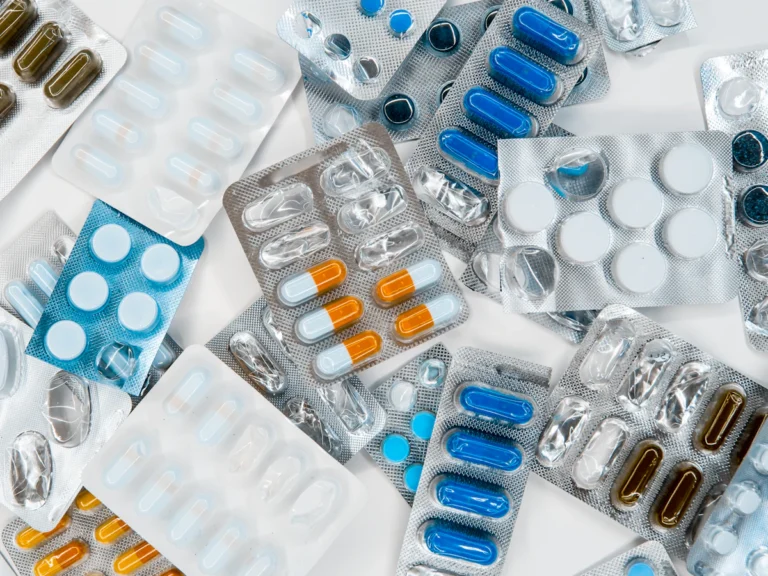 A pile of pills sitting next to each other on top of a table