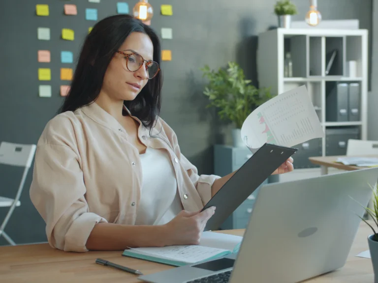Woman working with documents at office desk