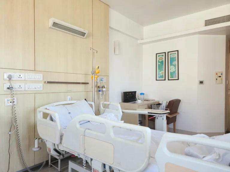 A hospital room with a bed and a desk