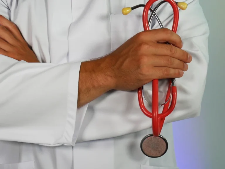 Doctor holding red stethoscope