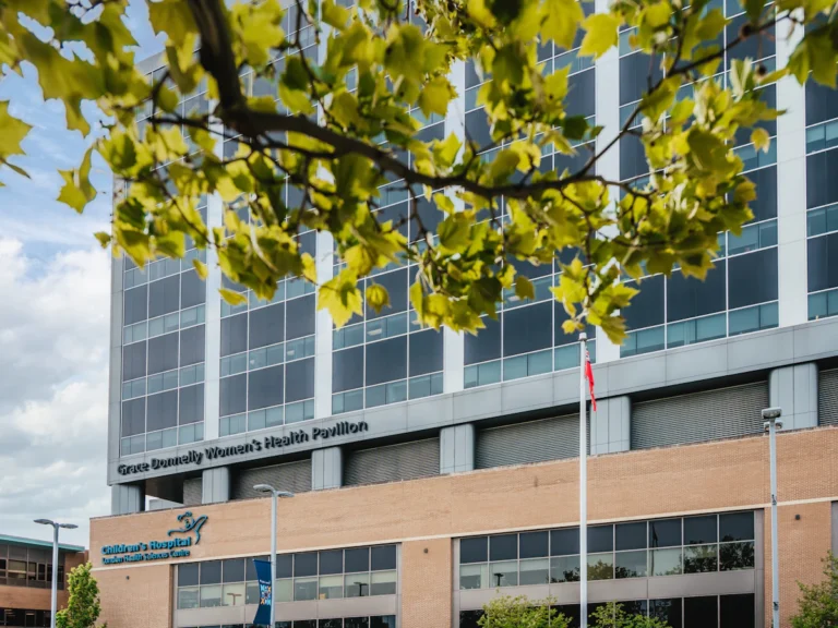 Modern hospital building with trees in foreground