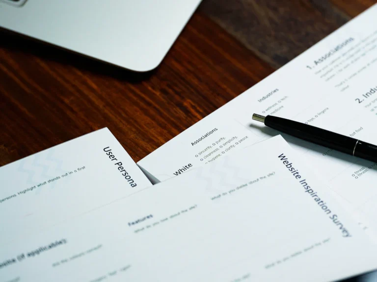 A pen sitting on top of a pile of papers