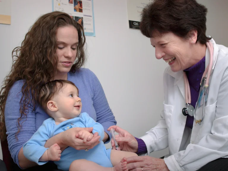 A young child is being examined by a doctor