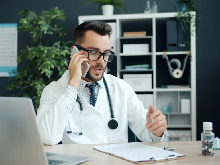 Doctor talking on the phone in his office