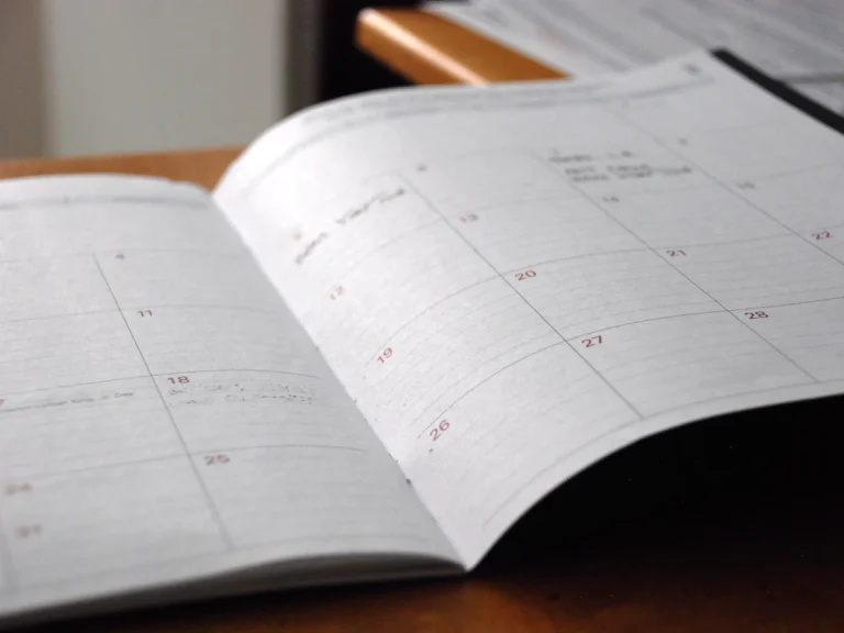 Open monthly planner on wooden desk