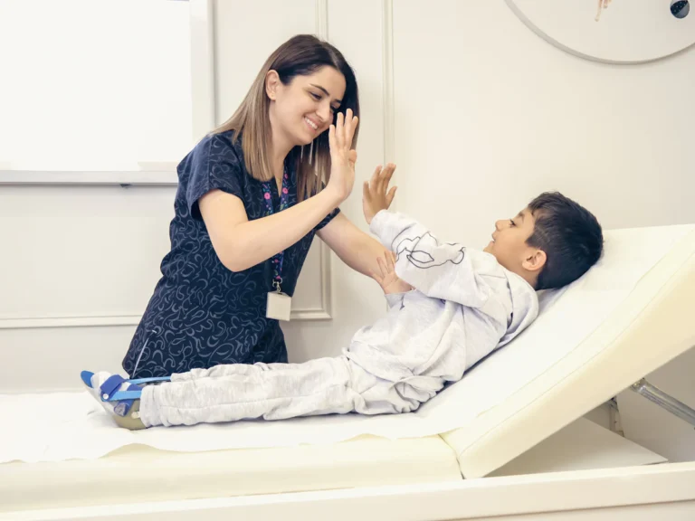 A woman is giving a boy a high five