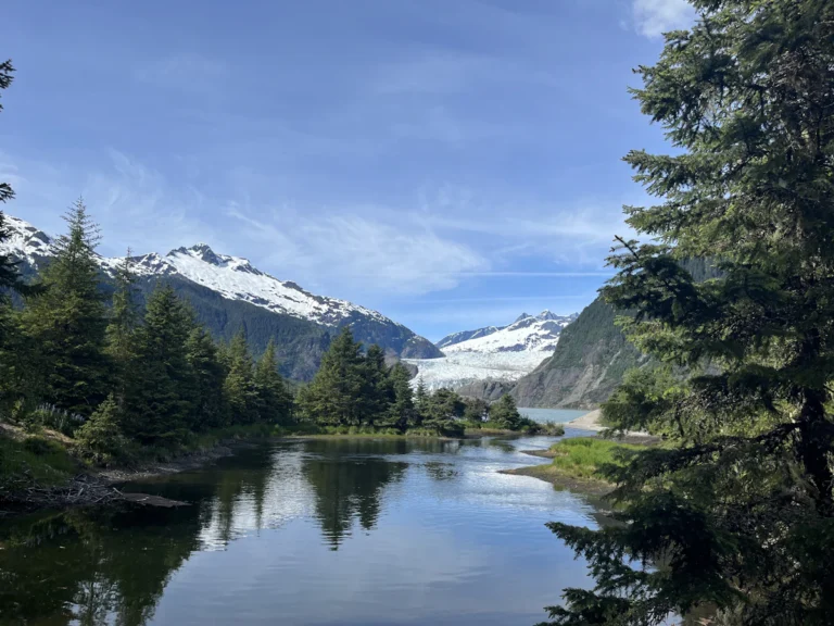 A lake surrounded by trees and mountains