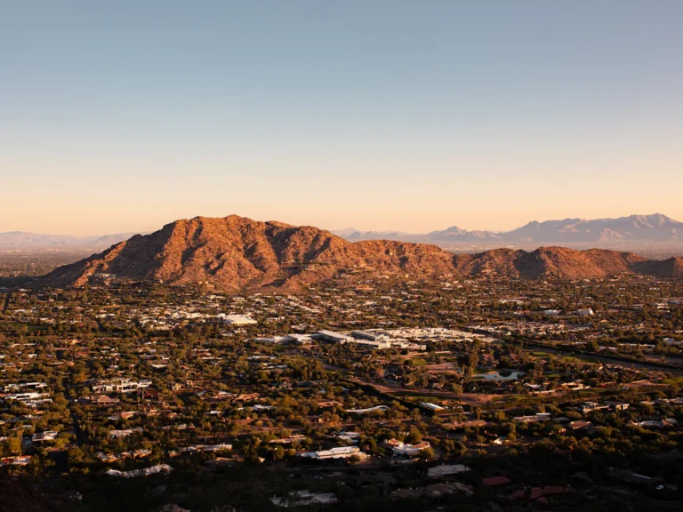 An aerial view of a city with mountains in the background