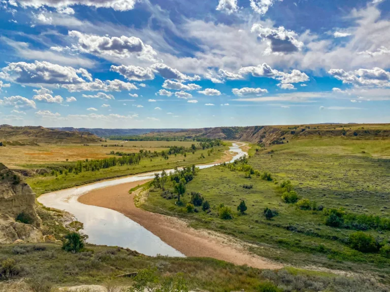 A river running through a lush green valley