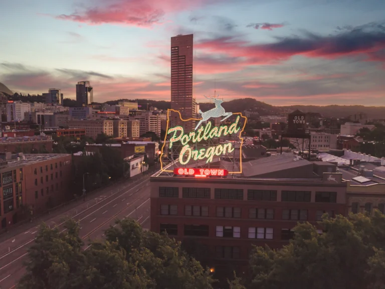 A large neon sign on top of a building