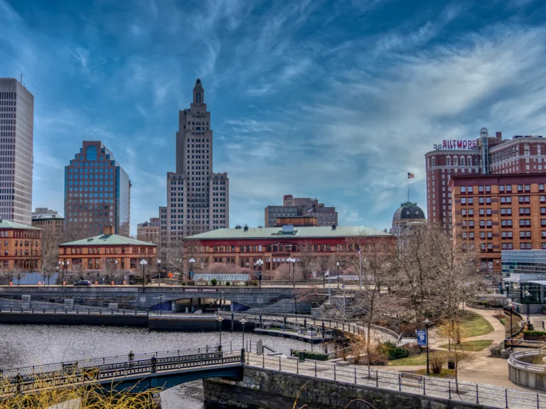 City skyline under blue sky and white clouds during daytime