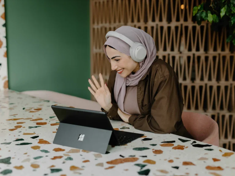 A person sitting on a table with a laptop