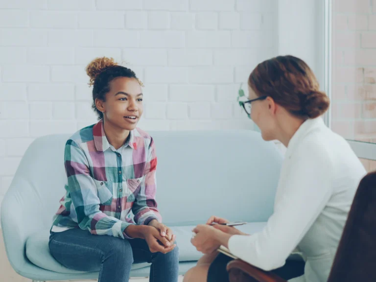 Two women talking in a modern office setting