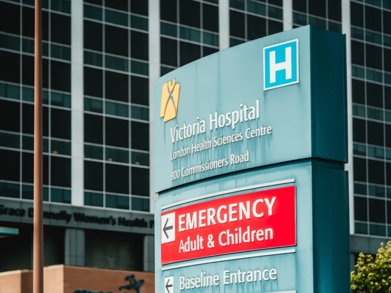 Victoria hospital emergency entrance sign with building