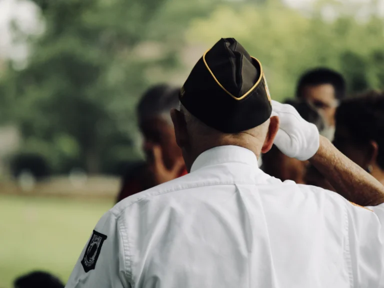 Man wearing white uniform saluting