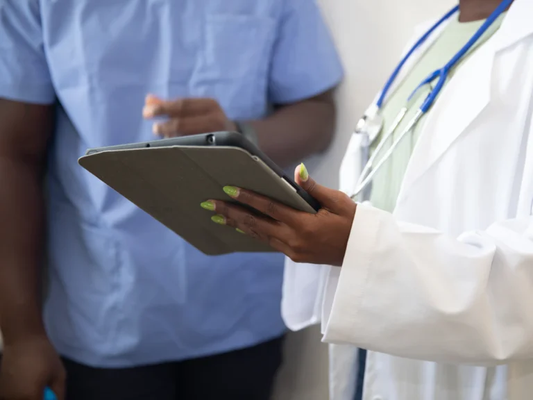 A doctor showing a patient something on the tablet